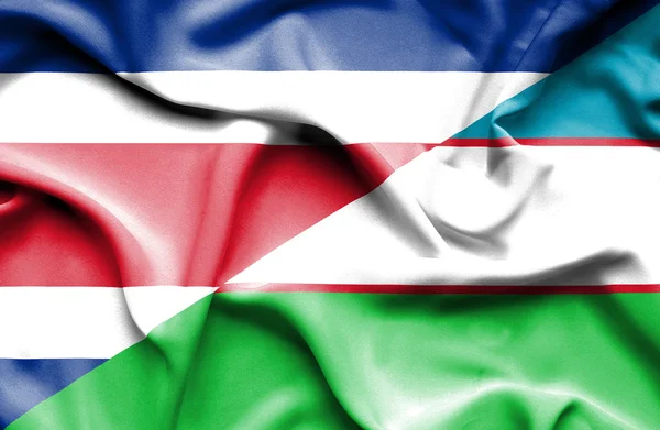 Waving flag of Uzbekistan and Costa Rica — Stock Photo, Image