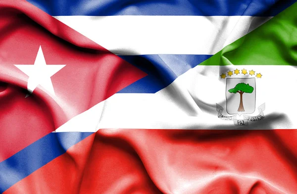 Macha flagą poprzecznego Giuinea i Kuba — Zdjęcie stockowe