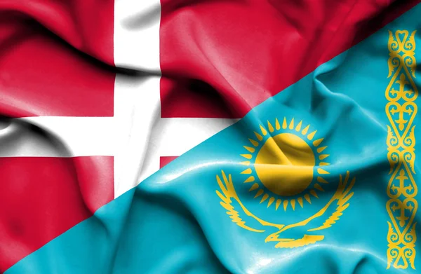 Waving flag of Kazakhstan and Denmark — Stock Photo, Image