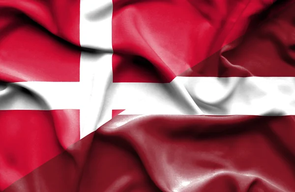 Waving flag of Latvia and Denmark — Stock Photo, Image