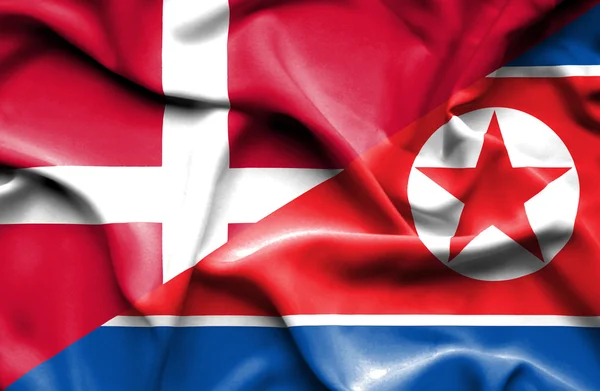 Mávání vlajkou Severní Koreje a Dánsko — Stock fotografie