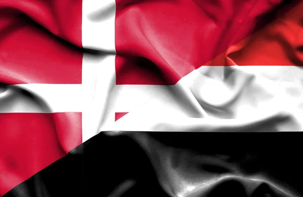 Waving flag of Yemen and Denmark — Stock Photo, Image