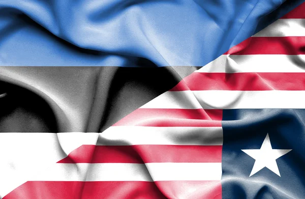 Waving flag of Liberia and Estonia — Stock Photo, Image