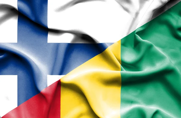 Vlající vlajka Guiney a Finsko — Stock fotografie