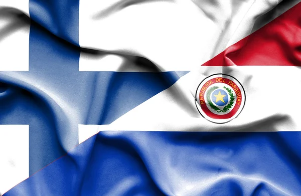 Flagge von Paraguay und Finnland geschwenkt — Stockfoto