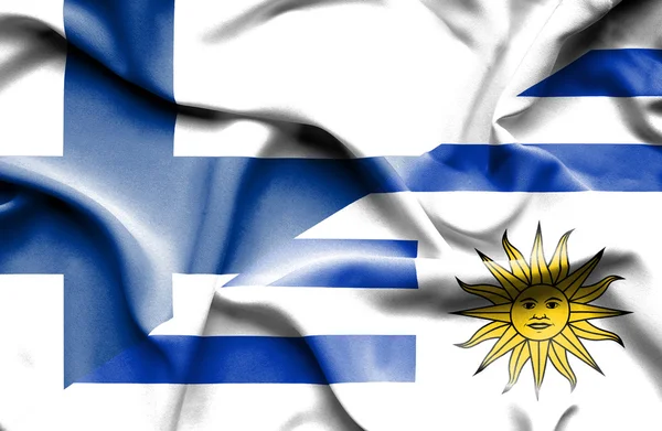 Waving flag of Uruguay and Finland — Stock Photo, Image