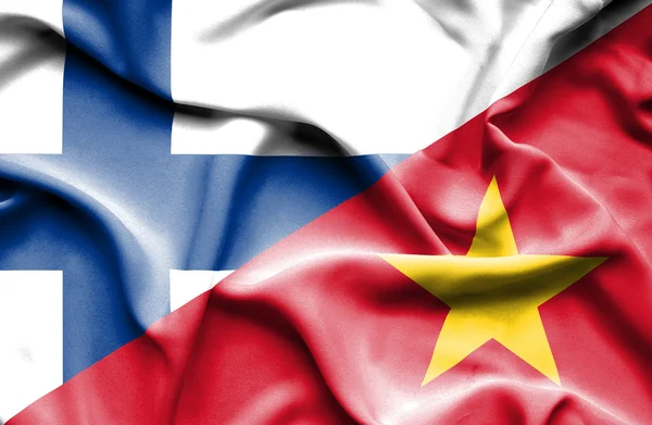 Wapperende vlag van Vietnam en Finland — Stockfoto