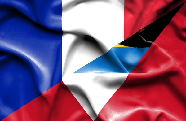 Waving flag of Antigua and Barbuda and France — Stock Photo, Image