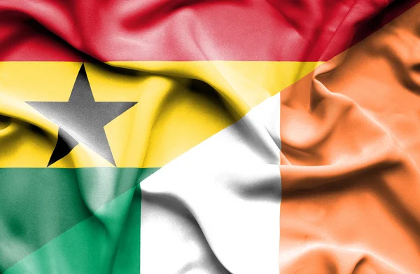 Waving flag of Ireland and Ghana — Stock Photo, Image