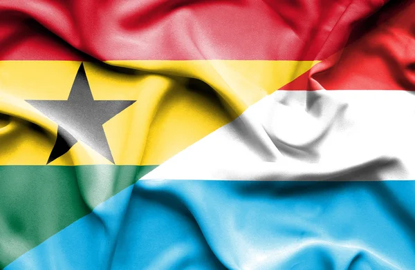 Waving flag of Luxembourg and Ghana — Stock Photo, Image