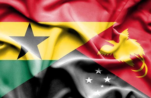 Flagge von Papua Neuguinea und Ghanaschwenken — Stockfoto