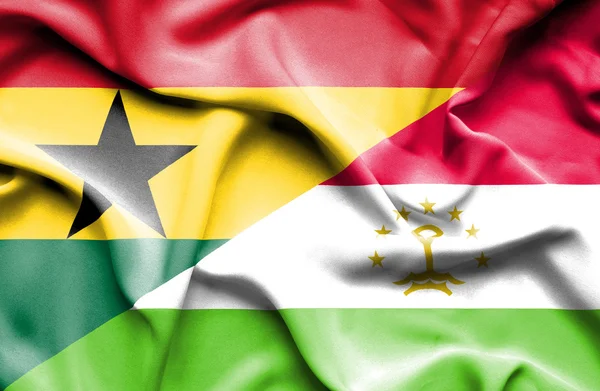 Ondeando la bandera de Tayikistán y Ghana — Foto de Stock