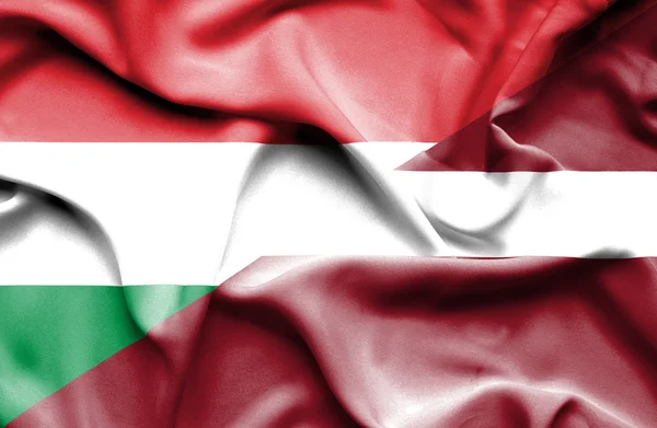 Waving flag of Latvia and Hungary — Stock Photo, Image