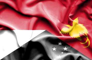 Waving flag of Papua New Guinea and Indonesia clipart