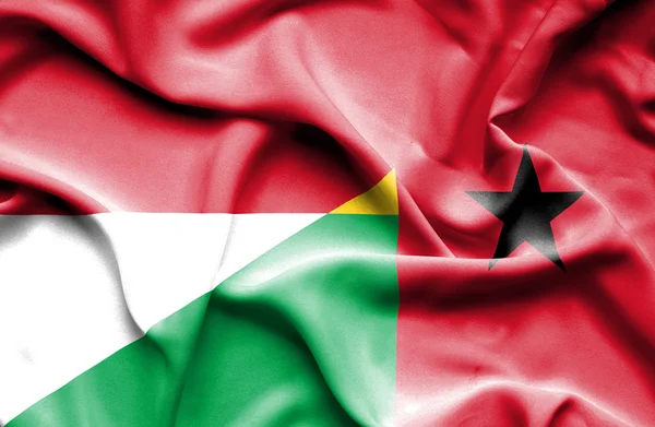 Guinea Bissau och Indonesien viftande flagga — Stockfoto