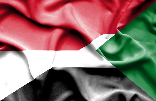 Waving flag of Sudan and Indonesia — Stock Photo, Image