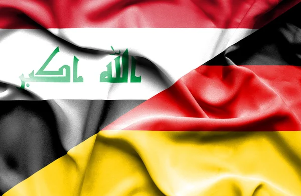 Macha flagą Niemiec i Iraku — Zdjęcie stockowe
