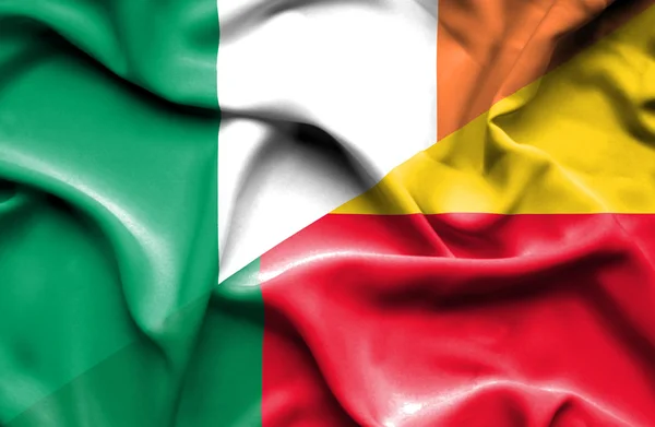 Waving flag of Benin and Ireland — Stock Photo, Image