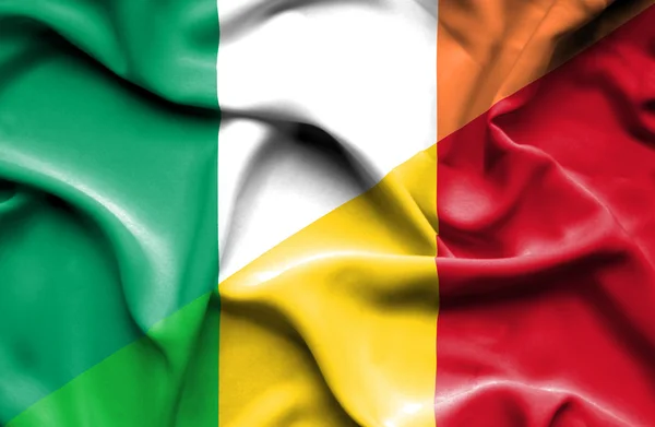 Waving flag of Mali and Ireland — Stock Photo, Image