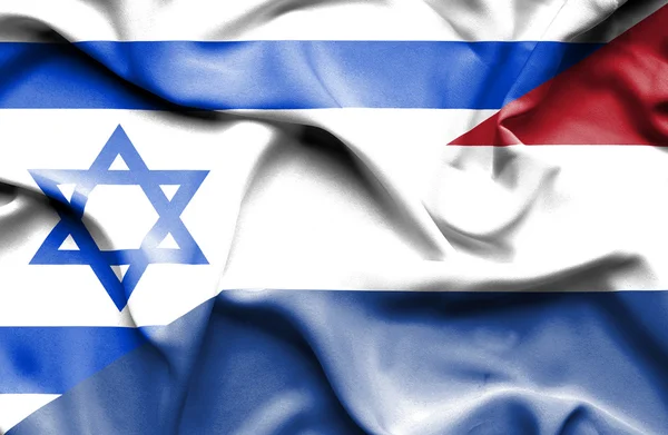 Macha flagą Holandii i Izraela — Zdjęcie stockowe