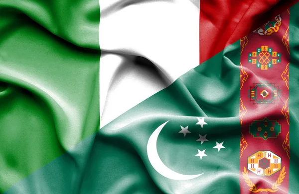 Waving flag of Turkmenistan and Italy — Stock Photo, Image