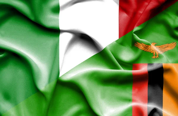 Waving flag of Zimbabwe and Italy — Stock Photo, Image