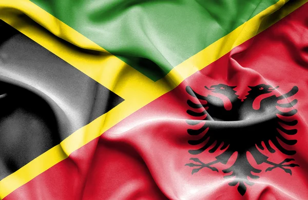 Waving flag of Albania and Jamaica — Stock Photo, Image