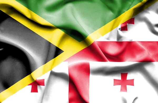 Waving flag of Georgia and Jamaica — Stock Photo, Image