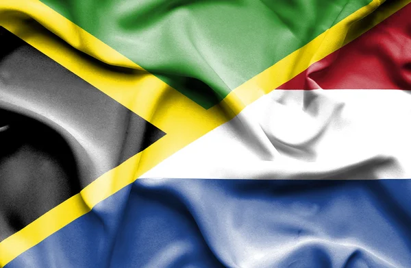 Nederländerna och Jamaica viftande flagga — Stockfoto