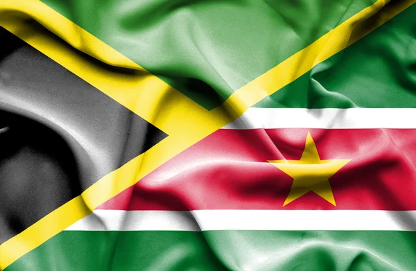 Waving flag of Suriname and Jamaica — Stock Photo, Image