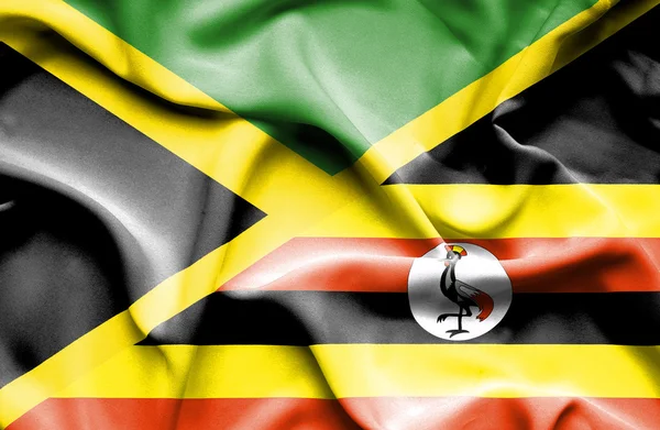 Waving flag of Uganda and Jamaica — Stock Photo, Image