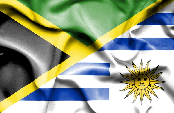Waving flag of Uruguay and Jamaica — Stock Photo, Image