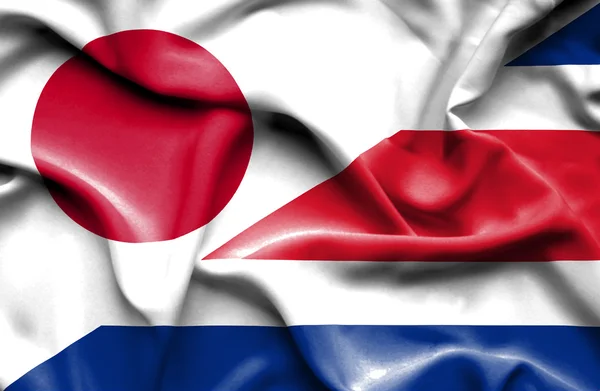 Waving flag of Costa Rica and Japan — Stock Photo, Image