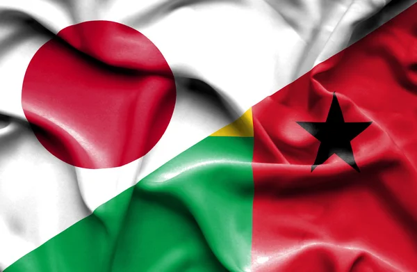 Wapperende vlag van Guinee-Bissau en Japan — Stockfoto