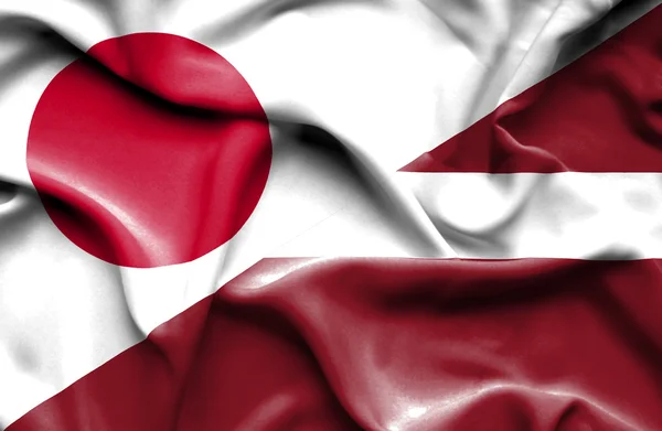 Waving flag of Latvia and Japan — Stock Photo, Image