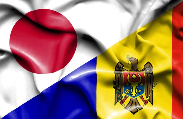 Mávání vlajkou Moldávie a Japonska — Stock fotografie