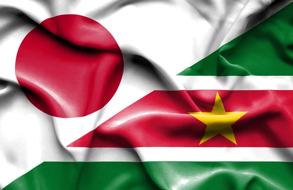 Wapperende vlag van Suriname en Japan — Stockfoto