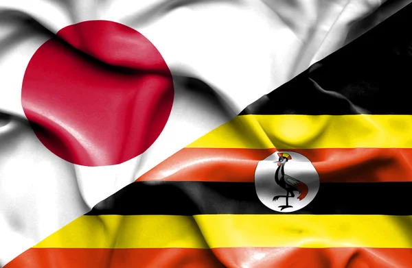 Bandera ondeante de Uganda y Japón — Foto de Stock