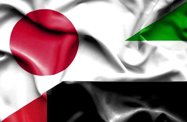 Wapperende vlag van Verenigde Arabische Emiraten en Japan — Stockfoto