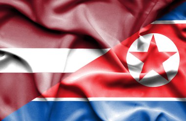 Kuzey Kore ve Letonya bayrağı sallayarak