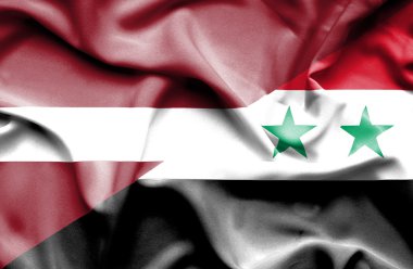 Suriye ve Letonya bayrağı sallayarak