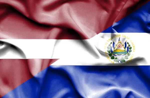Waving flag of El Salvador and Latvia — Stock Photo, Image