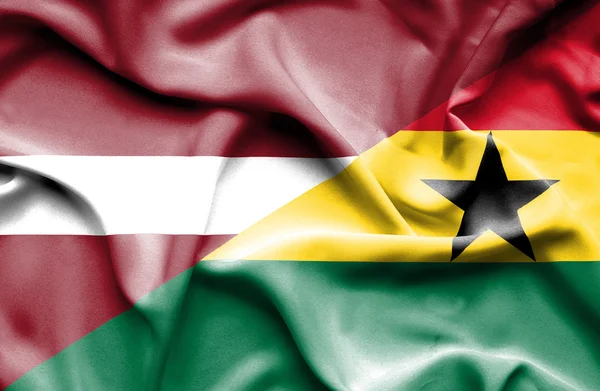 Waving flag of Ghana and Latvia — Stock Photo, Image