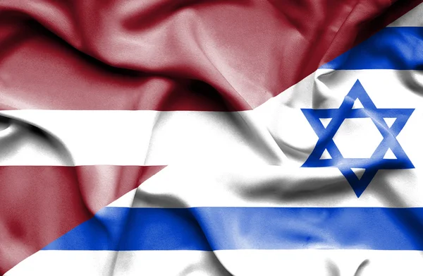 Waving flag of Israel and Latvia — Stock Photo, Image