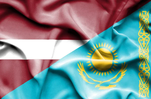 Waving flag of Kazakhstan and Latvia — Stock Photo, Image