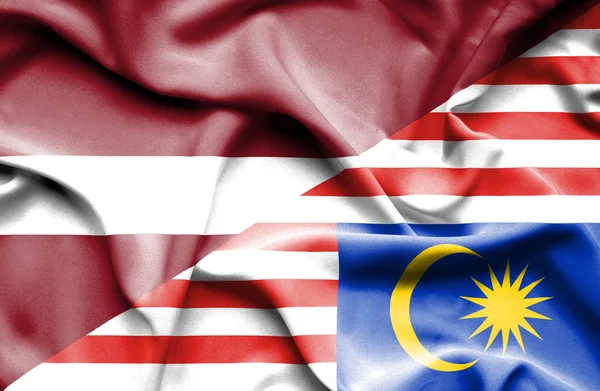 Waving flag of Malaysia and Latvia — Stock Photo, Image