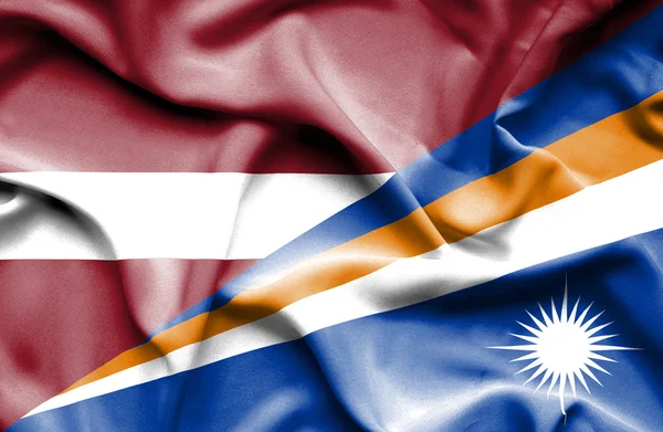 Waving flag of Marshall Islands and Latvia — Stock Photo, Image