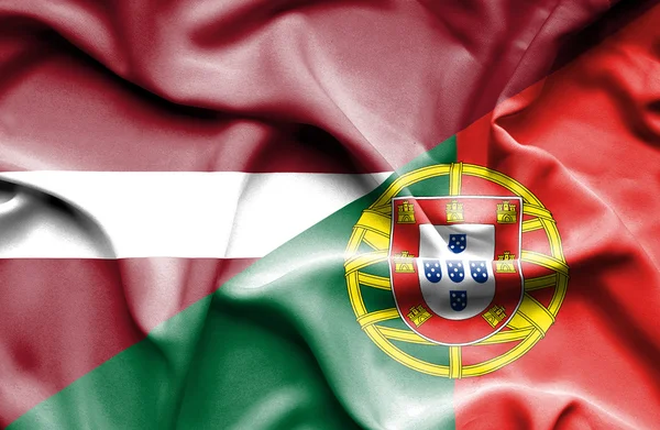 Bandera ondeante de Portugal y Letonia —  Fotos de Stock