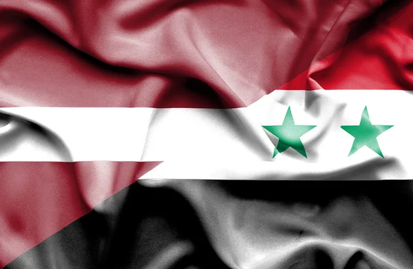 Suriye ve Letonya bayrağı sallayarak