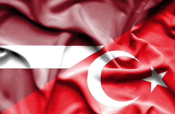 Waving flag of Turkey and Latvia — Stock Photo, Image